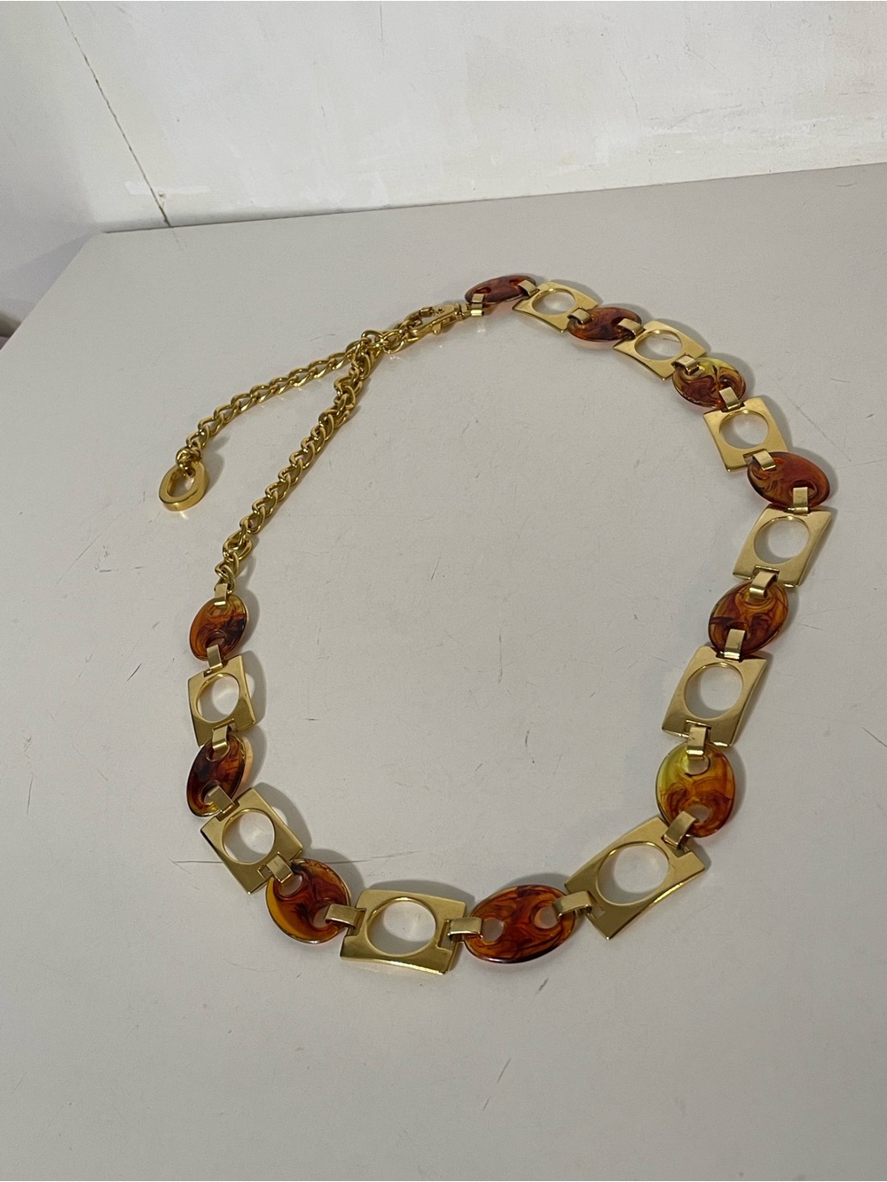 Tortoise and gold chain belt